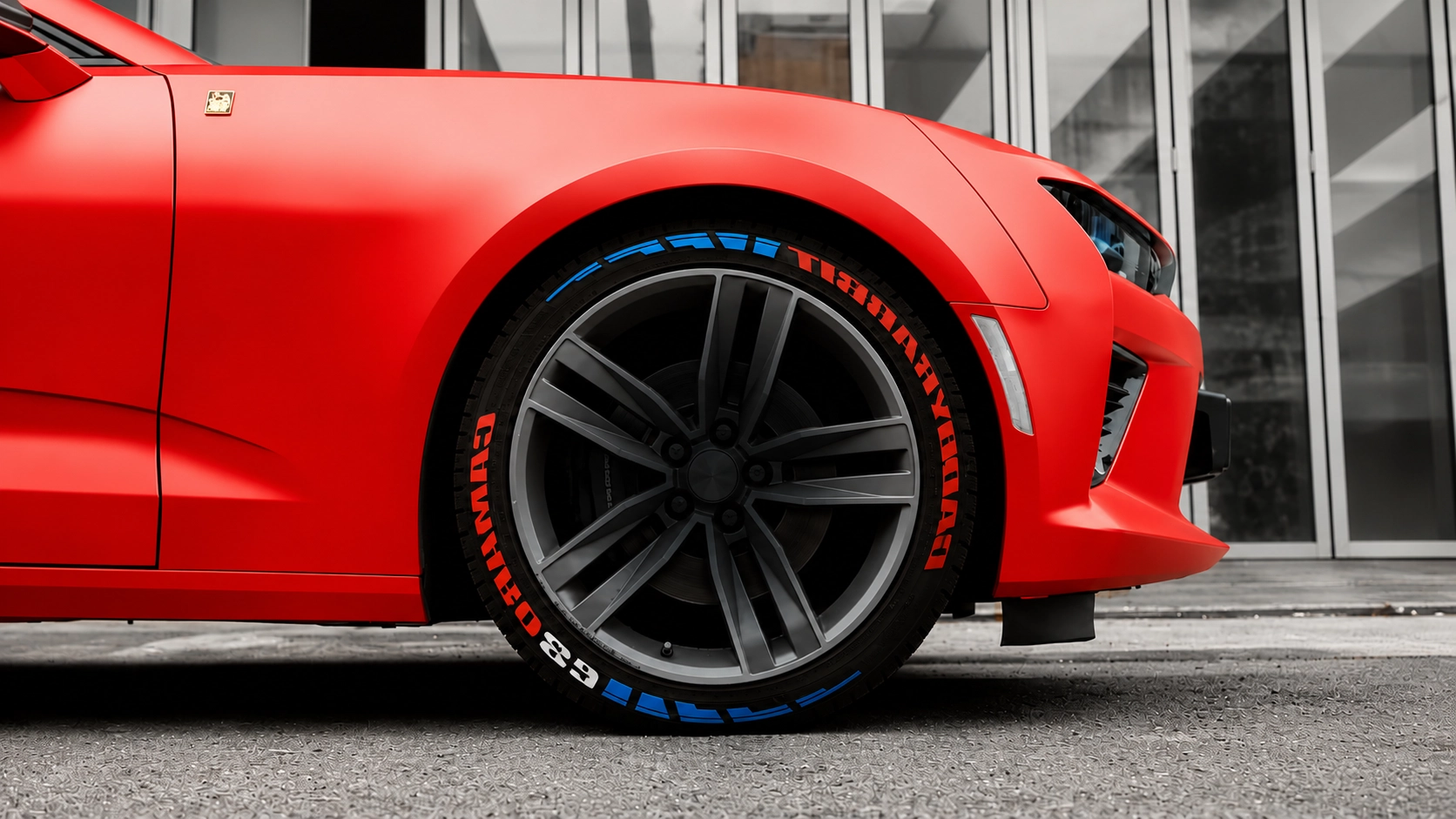Red Camaro SS wheel with custom red, white and blue raised-rubber tire lettering